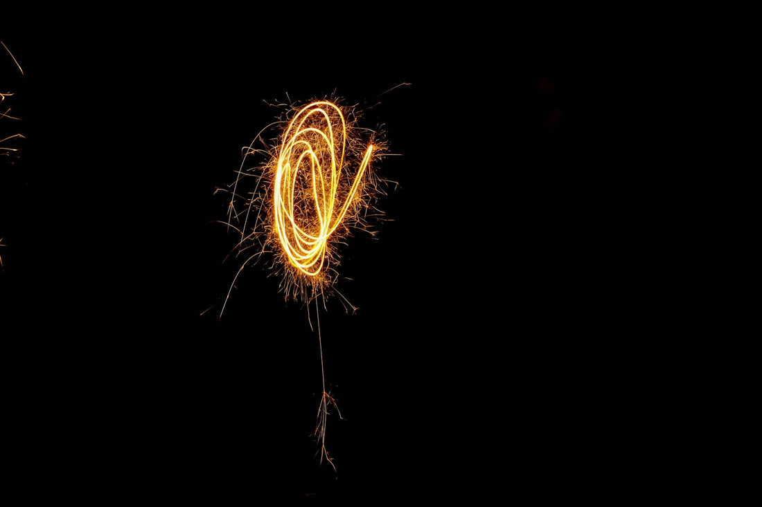 Sparkler light trails against a dark night sky on Bonfire Night